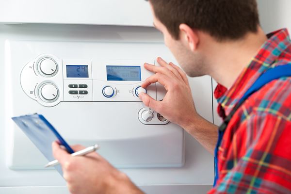 Technician servicing the gas boiler for hot water and heating